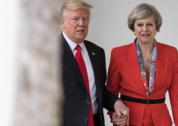 Theresa May holds hands with Donald Trump in January 2017 shortly after he took office as US President (Picture: Christopher Furlong/Getty Images)