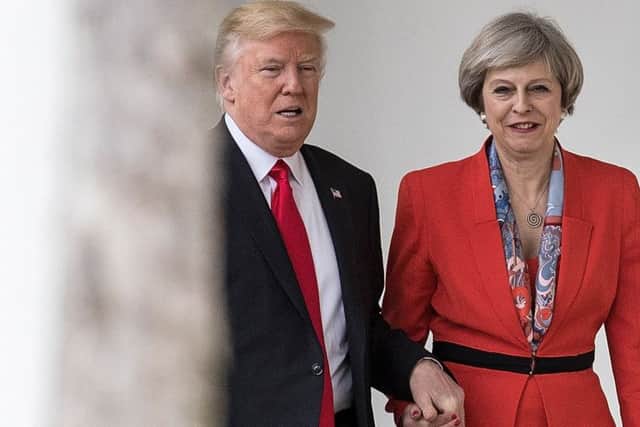 Theresa May holds hands with Donald Trump in January 2017 shortly after he took office as US President (Picture: Christopher Furlong/Getty Images)