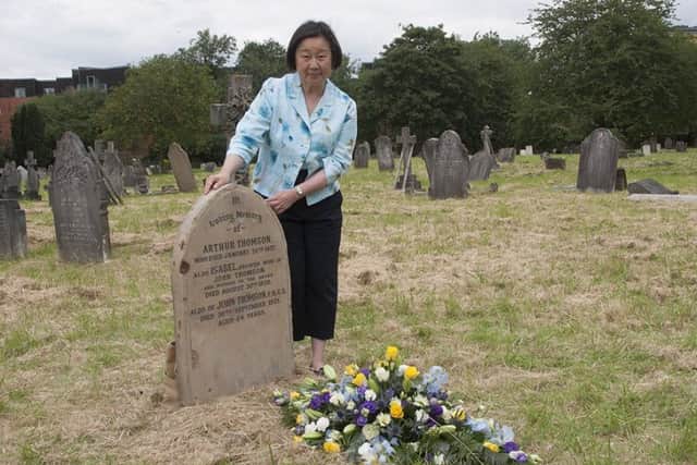 Betty Yao at Thomson's restored grave. Picture: The Wellcome Library