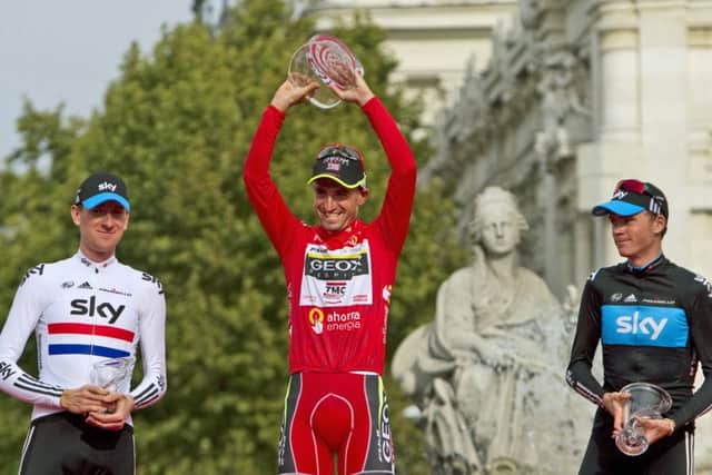 The 2011 Vuelta podium with Chris Froome, right, the now-disqualified Juan Jose Cobo, centre, and Bradley Wiggins. Picture: Arturo Rodriguez/AP