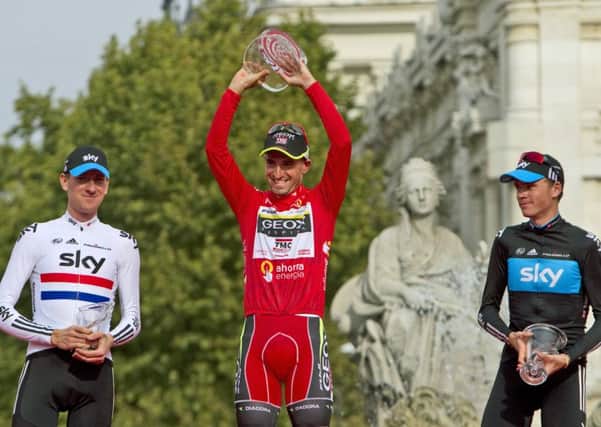 The 2011 Vuelta podium with Chris Froome, right, the now-disqualified Juan Jose Cobo, centre, and Bradley Wiggins. Picture: Arturo Rodriguez/AP
