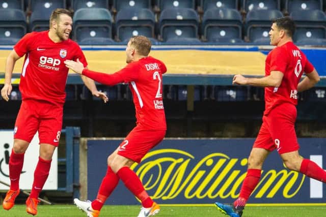 Connah's Quay Nomads' players run off to celebrate after netting the crucial goal.