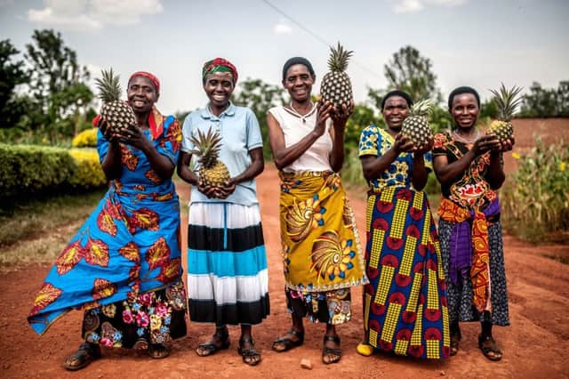 Tuzamurane cooperative members stand outside the cooperative centre in Eastern Rwanda, Kirehe District. From left to right: Theresie Nyirantozi, Valerie Mukangerero, Christine Bangiwiha, Josepha Ayinkamiye, Mukeshimana Leocadie.