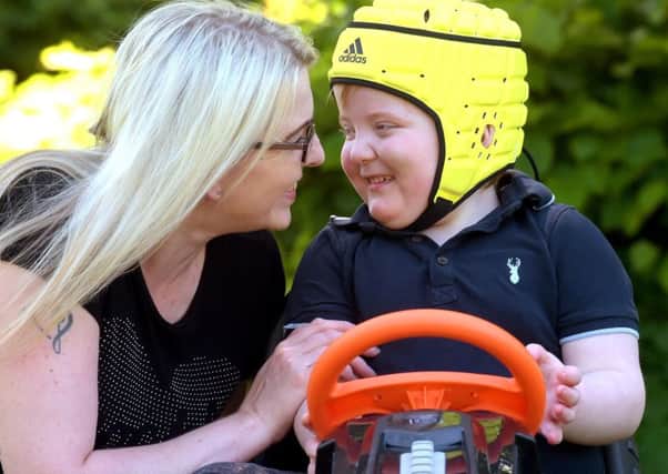 Karen Gray with Murray who is now able to play and attend school. Photograph: Lisa Ferguson