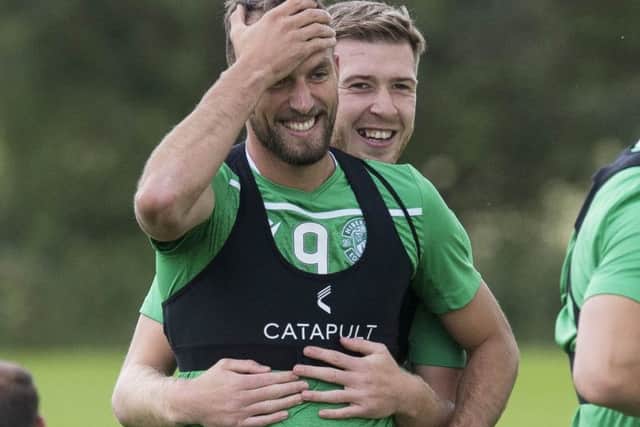 Christian Doidge, left, and Josh Vela get friendly during a Hibs training session. Picture: Paul Devlin/SNS