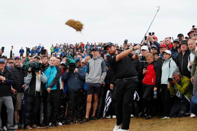 Shane Lowry takes a huge divot as he plays a shot on the 17th. Picture: Kevin C. Cox/Getty