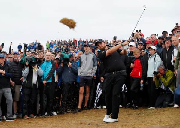 Shane Lowry takes a huge divot as he plays a shot on the 17th. Picture: Kevin C. Cox/Getty