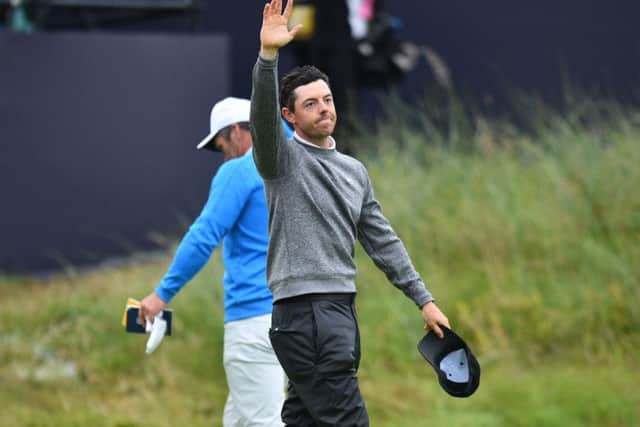 Rory McIlroy says farewell on the 18th green as he makes an early exit from his home Open. Picture: Glyn Kirk/AFP/Getty Images
