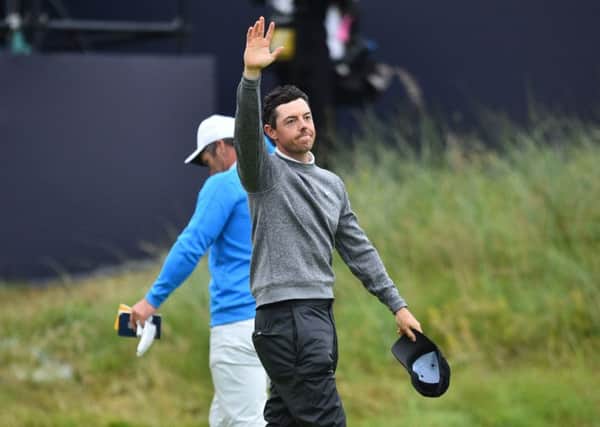 Rory McIlroy says farewell on the 18th green as he makes an early exit from his home Open. Picture: Glyn Kirk/AFP/Getty Images