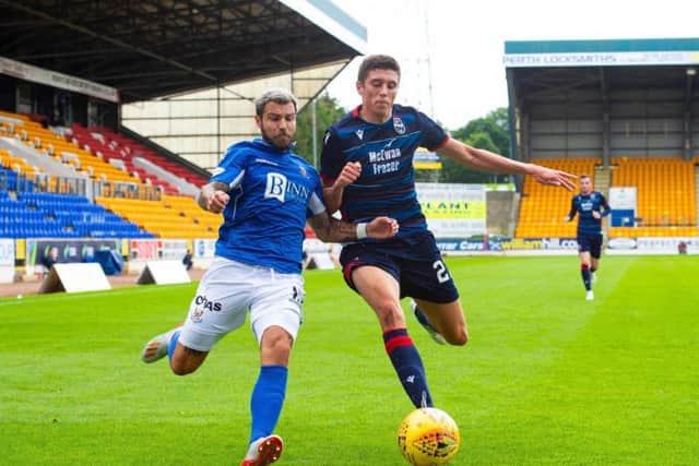 Richard Foster of St Johnstone and Ross County's Ross Stewart battle for the ball at McDiarmid Park