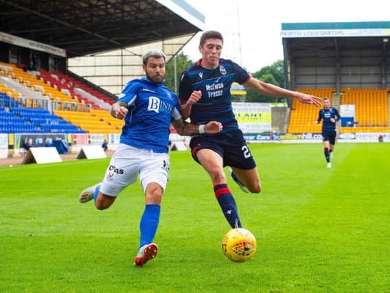 Richard Foster of St Johnstone and Ross County's Ross Stewart battle for the ball at McDiarmid Park
