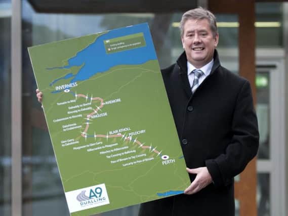 MSP Keith Brown with a map of the A9 dualling project