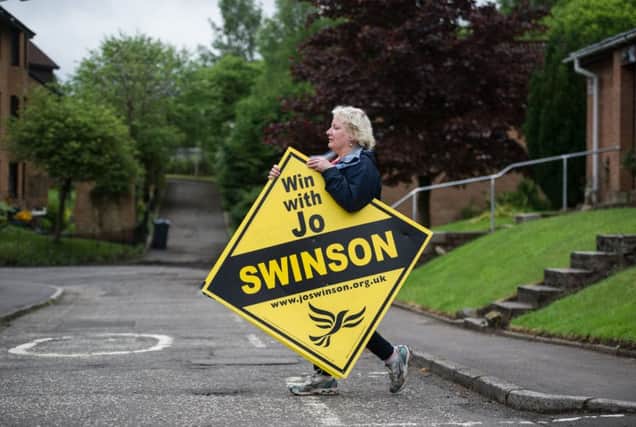 Lib Dem supporters erect signs promoting Jo Swinson in Bearsden ahead of the 2017 snap general election, which saw her return as an MP. Picture: John Devlin