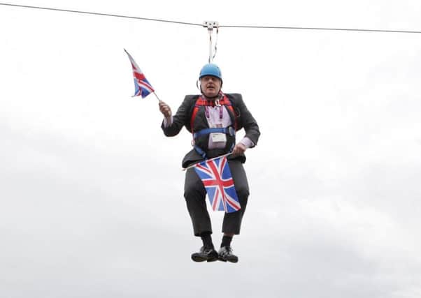 Boris Johnson waves a Union Jack flag while stuck on a zip-wire
