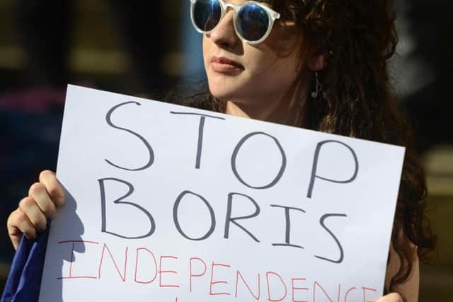 A protestor holds up an anti-Boris sign.