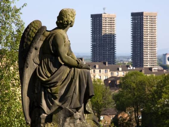 Glasgow Necropolis burial ground statue of Victorian angel contemplating two modern high rise tower blocks against the skyline. (Picture: Shutterstock)