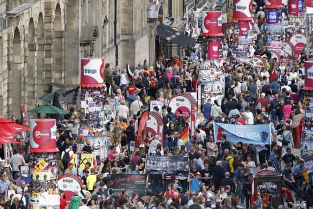 Tourists pack the Royal Mile during the Festival, bringing in revenue but changing the character of the city (Picture: Jane Barlow/PA)