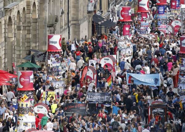 Tourists pack the Royal Mile during the Festival, bringing in revenue but changing the character of the city (Picture: Jane Barlow/PA)