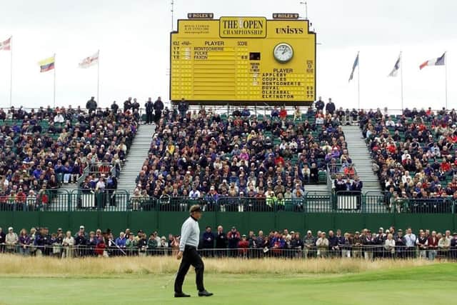 The scoreboard shows Colin Montgomerie is the early leader as the Scot is applauded by the gallery on his way to the 18th green during the first day of the Open at Royal Lytham in 2001. Picture: AFP/Getty