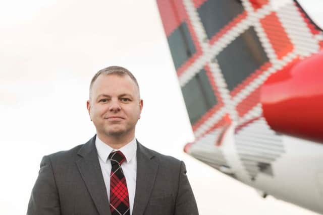 Loganair MD Jonathan Hinkles with one of the carriers Embraer aircraft. Picture: contributed