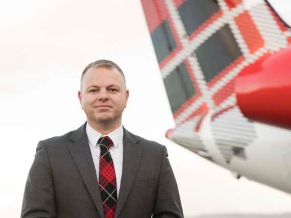 Loganair MD Jonathan Hinkles with one of the carriers Embraer aircraft. Picture: contributed