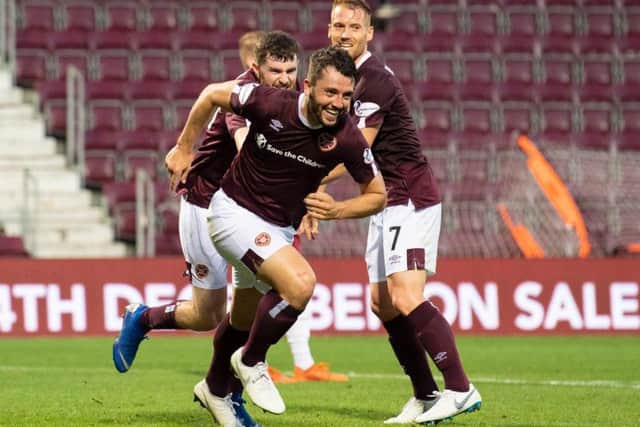 Craig Halkett wheels away after scoring for Hearts