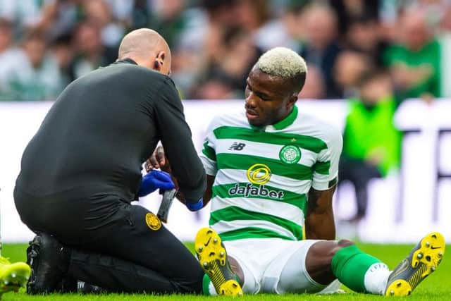 Celtic physio Tim Williamson tends to stricken defender Boli Bolingoli-Mbombo