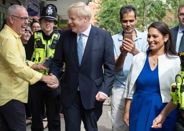 Boris Johnson greets members of the public on a walkabout with Home Secretary Priti Patel in Birmingham. Picture: Getty