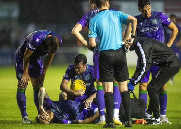 Hibs players console Martin Boyle after the winger went down injured late on against Elgin. Picture: Craig Foy/SNS