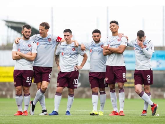 Hearts players watch the penalty shoot-out.