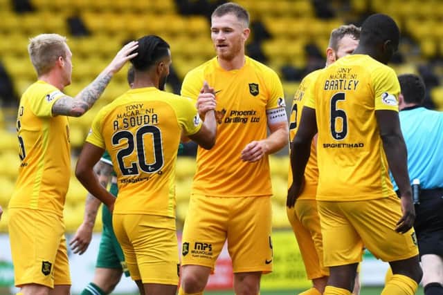 Livingston's Alan Lithgow celebrates his sides third goal with teammates