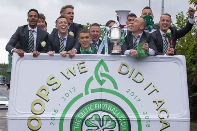The triumphant Celtic players enjoy an open-top bus ride around Glasgow following their victory in last season's Betfred Cup final. Picture: SNS.