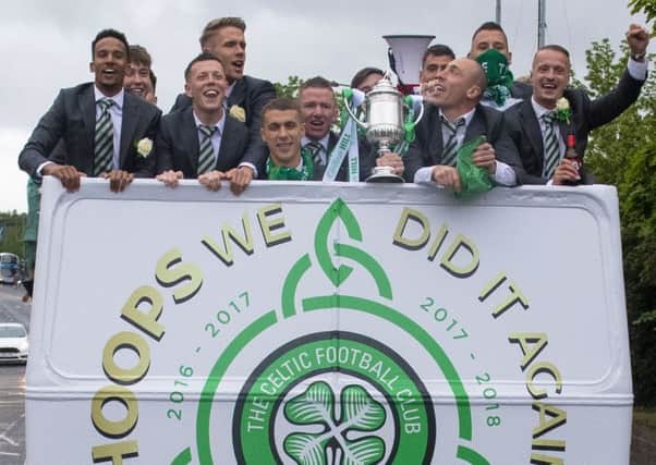 The triumphant Celtic players enjoy an open-top bus ride around Glasgow following their victory in last season's Betfred Cup final. Picture: SNS.