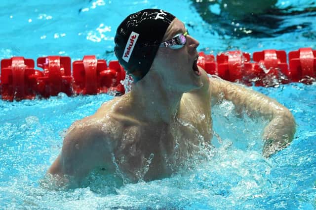 Duncan Scott lets out a roar of triumph after anchoring the Great Britain team to victory in the 4x400m medley at the World Championships in Gwangju. Picture: AFP/Getty.