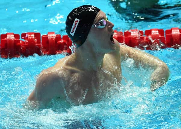 Duncan Scott lets out a roar of triumph after anchoring the Great Britain team to victory in the 4x400m medley at the World Championships in Gwangju. Picture: AFP/Getty.