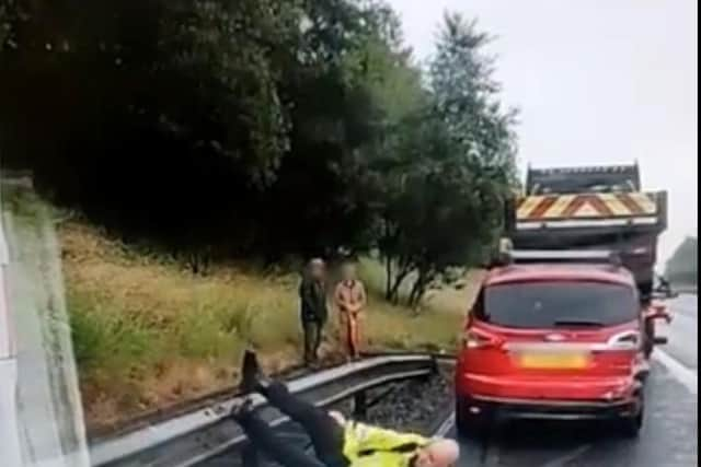 The officer ends up flat on his back after taking a tumble.