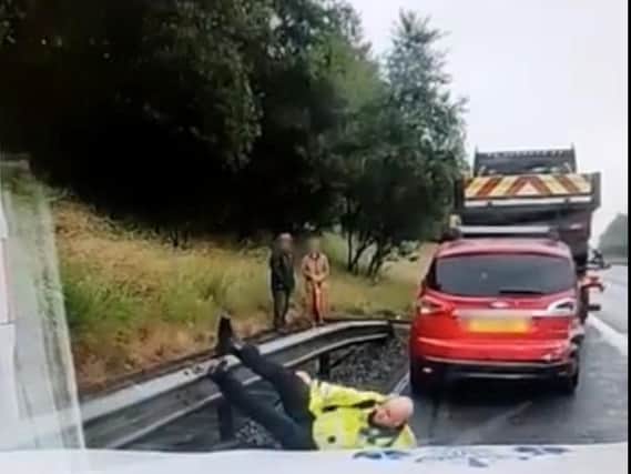 The officer ends up flat on his back after taking a tumble.
