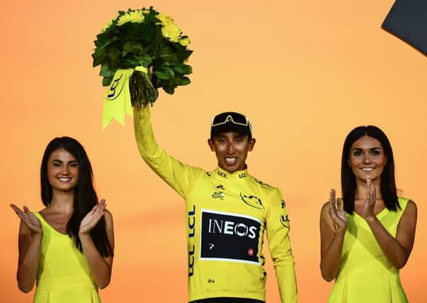 Egan Bernal celebrates on the podium in the leaders yellow jersey after securing victory in the Tour de France. Picture: AFP/Getty.
