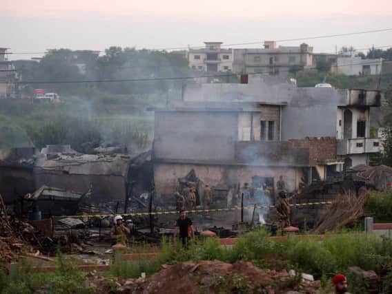 Soldiers cordoned off the site where the Pakistani Army Aviation Corps aircraft crashed in Rawalpindi. Picture: AP