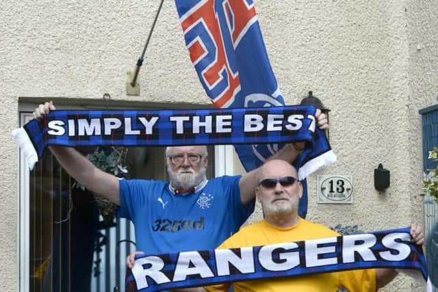 A pair of Rangers-daft pensioners have been told to take down flags outside their homes. Picture: SWNS