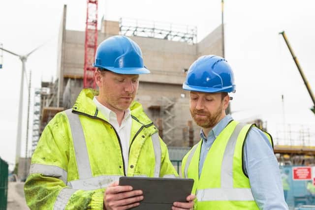 Caltech Lifts MD Andrew Renwick (right) looks over the plans for the industrial lift installation with brother and technical director Fraser Renwick. Picture: ASM Media