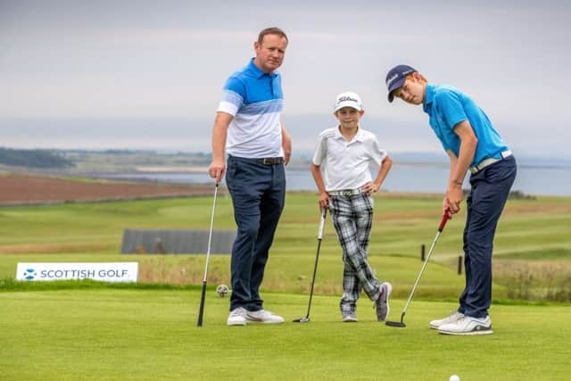 Stuart Graham and sons Gregor (15) and Connor (12) get in some putting practice. Picture: Kenny Smith