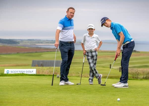 Stuart Graham and sons Gregor (15) and Connor (12) get in some putting practice. Picture: Kenny Smith