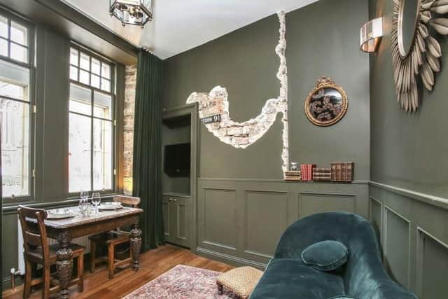 The living room has a small dining area and Harry Potter themed decoration.