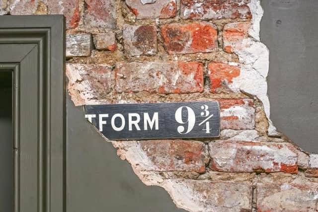 The flat features a few Harry Potter inspired decorations, such as this platform 9 3/4 sign.