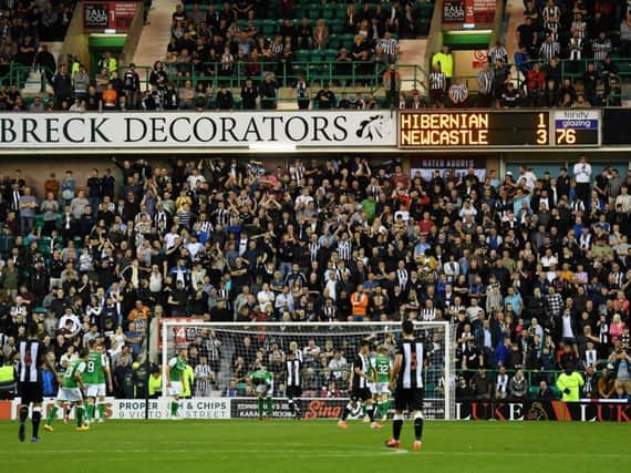 Newcastle United fans in the away end at Easter Road.
