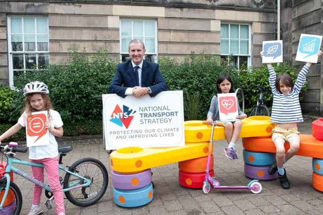 Transport secretary Michael Matheson visited Perth today, to mark the launch of the National Transport Strategy consultation. He is pictured here at Perth Library with Isabella MacDonald, seven, Elena Murphy, five, and Ethan Murphy, eight



(centre). Picture: Wullie Marr Photography