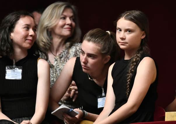 Greta Thunberg, right, has highlighted the lack of response to climate change by todays adults (Picture: Stephanie de Sakutin/AFP/Getty Images)
