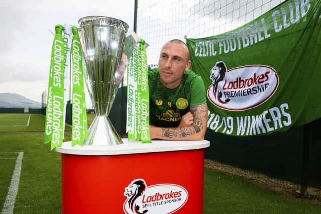Scott Brown with the Premiership flag and trophy. Picture: SNS