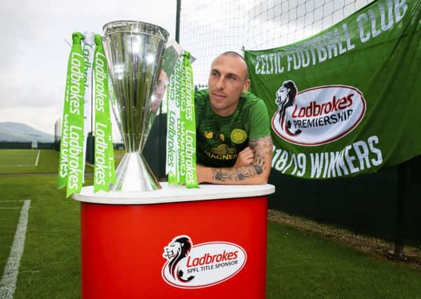 Scott Brown with the Premiership flag and trophy. Picture: SNS
